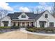 Charming white farmhouse with a covered porch and manicured landscaping at 8710 Little Mill Rd, Cumming, GA 30041