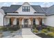 Charming home with white siding, black trim, wood columns, and inviting front porch at 8710 Little Mill Rd, Cumming, GA 30041