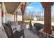 Spacious front porch with wooden columns, rocking chairs, and view of the detached garage at 8710 Little Mill Rd, Cumming, GA 30041