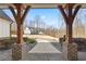 Wide front porch framed by wooden columns provides picturesque views of the expansive property at 8710 Little Mill Rd, Cumming, GA 30041
