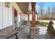 Covered front porch with brick columns and rocking chairs creates a welcoming entrance at 8710 Little Mill Rd, Cumming, GA 30041