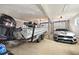 A spacious garage featuring a boat, car, and natural light at 8710 Little Mill Rd, Cumming, GA 30041