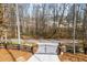 Gated driveway entrance lined with wooden fencing and lush landscaping at 8710 Little Mill Rd, Cumming, GA 30041
