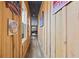 Long wood paneled hallway showcasing vintage signage and natural light at 8710 Little Mill Rd, Cumming, GA 30041