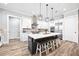 Open kitchen with a large island, stainless steel appliances, and modern finishes at 8710 Little Mill Rd, Cumming, GA 30041