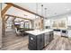 Open concept kitchen with a large island, stainless steel appliances, and brick accents at 8710 Little Mill Rd, Cumming, GA 30041
