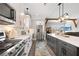 Bright kitchen featuring a stainless steel refrigerator, an island with a white countertop, and modern appliances at 8710 Little Mill Rd, Cumming, GA 30041