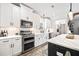 Updated kitchen with white cabinets, stainless steel appliances, marble backsplash, and a center island at 8710 Little Mill Rd, Cumming, GA 30041