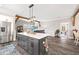 Kitchen island featuring overhead lighting, wooden beams, and stainless steel refrigerator in an open floor plan at 8710 Little Mill Rd, Cumming, GA 30041