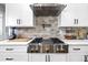 Modern kitchen featuring stainless steel appliances and white cabinets at 8710 Little Mill Rd, Cumming, GA 30041