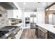 Modern kitchen featuring stainless steel appliances, white cabinets, and a center island with a wine cooler at 8710 Little Mill Rd, Cumming, GA 30041
