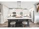 Kitchen island with a white countertop, barstool seating, and modern pendant lighting at 8710 Little Mill Rd, Cumming, GA 30041