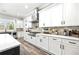 Beautiful kitchen with stainless steel appliances, white cabinets, and stone backsplash at 8710 Little Mill Rd, Cumming, GA 30041