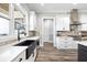 Bright kitchen featuring stainless steel appliances, a black farmhouse sink, and modern finishes at 8710 Little Mill Rd, Cumming, GA 30041
