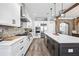 Open kitchen featuring a large island, stainless steel appliances, and modern lighting at 8710 Little Mill Rd, Cumming, GA 30041