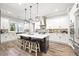 Spacious kitchen featuring a large island, stainless steel appliances, and modern lighting at 8710 Little Mill Rd, Cumming, GA 30041