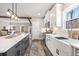Bright kitchen featuring white cabinetry, an island with quartz countertops, stainless appliances, and overhead lighting at 8710 Little Mill Rd, Cumming, GA 30041