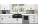 Bright kitchen featuring stainless steel appliances and a black farmhouse sink at 8710 Little Mill Rd, Cumming, GA 30041