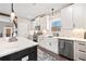 Bright kitchen featuring white cabinetry, an island with quartz countertops, and modern stainless steel appliances at 8710 Little Mill Rd, Cumming, GA 30041