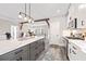 Kitchen island featuring overhead lighting, wooden beams, and modern appliances in an open floor plan at 8710 Little Mill Rd, Cumming, GA 30041