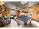 The living room features wood paneled walls, natural light, and comfortable seating at 8710 Little Mill Rd, Cumming, GA 30041