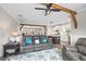 Open concept living room with hardwood floors, wood beam accents, and views of the kitchen and dining area at 8710 Little Mill Rd, Cumming, GA 30041