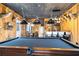 Open-concept living room with a pool table and bar area, perfect for entertaining at 8710 Little Mill Rd, Cumming, GA 30041