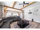 Open concept living room flows to the kitchen and features exposed wood beams and a large sectional at 8710 Little Mill Rd, Cumming, GA 30041