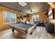 The living room features wood paneled walls, natural light, and comfortable seating at 8710 Little Mill Rd, Cumming, GA 30041