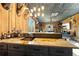 The living room features wood paneled walls, a home bar, and comfortable seating at 8710 Little Mill Rd, Cumming, GA 30041