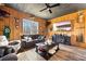 This living room features comfortable seating, wood paneled walls, and a large tv at 8710 Little Mill Rd, Cumming, GA 30041