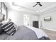 Comfortable main bedroom featuring tray ceiling, ceiling fan, and gray color scheme at 8710 Little Mill Rd, Cumming, GA 30041