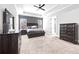Spacious main bedroom with a tray ceiling, ceiling fan, and wood furniture at 8710 Little Mill Rd, Cumming, GA 30041