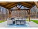 Cozy outdoor pavilion featuring comfortable seating, a ceiling fan, and scenic views for a relaxing retreat at 8710 Little Mill Rd, Cumming, GA 30041