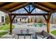Backyard living space under a wood pavilion with a pool view at 8710 Little Mill Rd, Cumming, GA 30041