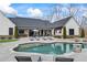 Inviting backyard with a gunite pool, covered patio, and an outdoor TV, perfect for enjoying leisure time at 8710 Little Mill Rd, Cumming, GA 30041