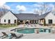 Beautiful backyard with a kidney-shaped pool, sun loungers, and an outdoor TV for relaxation and entertainment at 8710 Little Mill Rd, Cumming, GA 30041