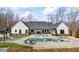 Stunning backyard with a gunite pool, sun loungers, and a covered outdoor kitchen area perfect for entertaining at 8710 Little Mill Rd, Cumming, GA 30041