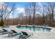Backyard pool area featuring lounge chairs and natural rock accents for a serene and luxurious outdoor experience at 8710 Little Mill Rd, Cumming, GA 30041