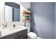 Charming powder room with floating wood shelves, modern vanity, and shiplap accent wall at 8710 Little Mill Rd, Cumming, GA 30041