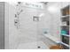 Glass-enclosed shower with marble tiling, built-in niche, and bench seating at 8710 Little Mill Rd, Cumming, GA 30041