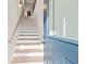 A wooden staircase leading to a bright, modern interior at 8710 Little Mill Rd, Cumming, GA 30041