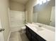 Modern bathroom with a dark vanity, white countertop, and a tub-shower combo at 2677 Pearl Ridge Trce, Buford, GA 30519