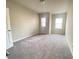 Spacious bedroom featuring carpet floors, neutral walls, and two windows offering plenty of natural light at 2677 Pearl Ridge Trce, Buford, GA 30519