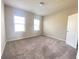 Bright bedroom featuring plush carpet, natural light, and a neutral color scheme at 2677 Pearl Ridge Trce, Buford, GA 30519