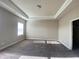 Bright bedroom featuring a large window and neutral walls complemented by a tray ceiling design at 2677 Pearl Ridge Trce, Buford, GA 30519