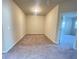 Empty bedroom with carpet floor, beige walls, and standard ceiling fan at 2677 Pearl Ridge Trce, Buford, GA 30519