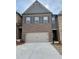 Two story brick home with a 2 car garage and dark shutters on the upper windows at 2677 Pearl Ridge Trce, Buford, GA 30519