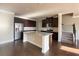 Open kitchen with a granite island, stainless steel appliances and dark wood floors at 2677 Pearl Ridge Trce, Buford, GA 30519