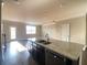 Kitchen island featuring dark cabinets, a granite top and stainless steel appliances at 2677 Pearl Ridge Trce, Buford, GA 30519